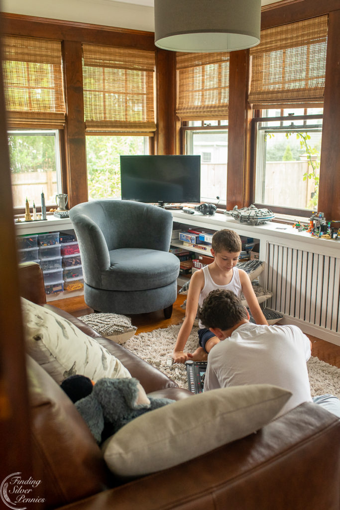 Boys playing in playroom with white walls and white shelves