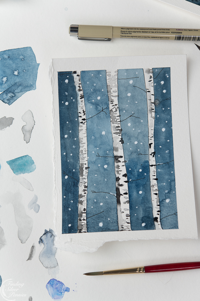Snowy birch tree painting with paint brush and scrap paper